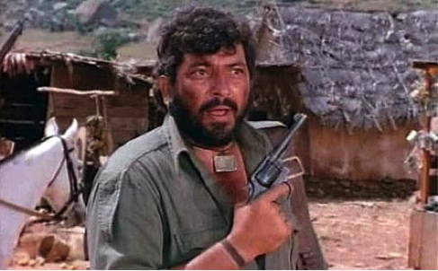 Figure 6: A still from Sholay (1975). Bandit Gabbar mouths off while his gang pillages villages