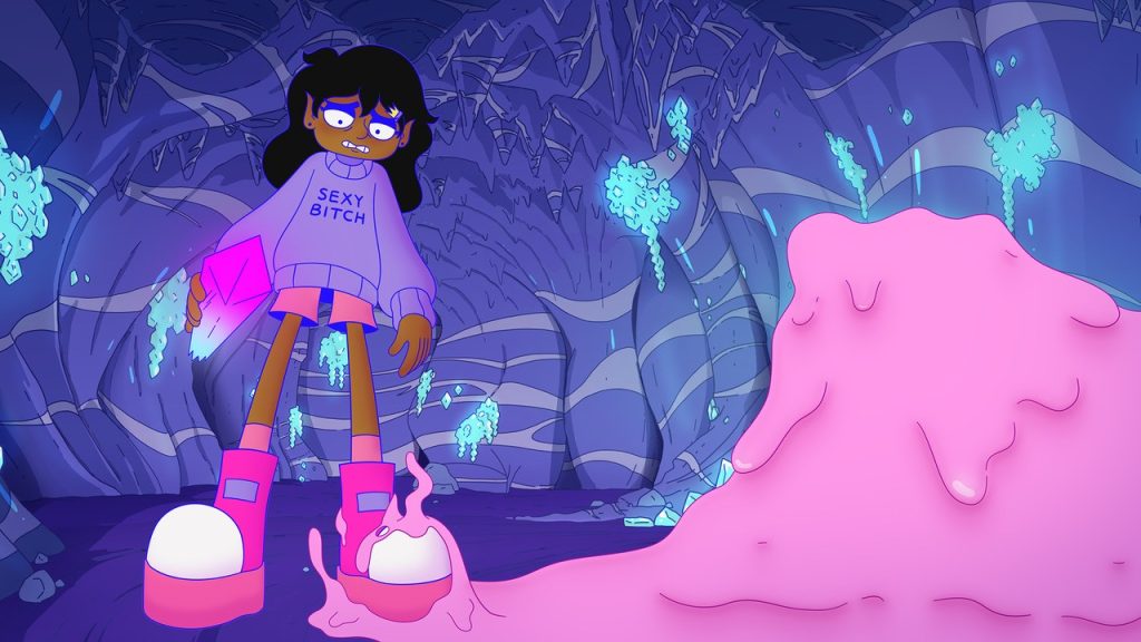 Still from Lesbian Space Princess (2025). Courtesy of Salzgeber. 
In a distorted, fish-eye like setting from a low angle the protagonist, Princess Saira, turned to the camera, stands in the center of the frame in a deep cave, surrounded by glowing blue crystals and lilac rock layers and stalactites. Her skin is dark brown; she has long black hair with short bangs held by a small golden crownshaped hairclip on the side and wears a lavender oversized sweater reading “SEXY BITCH” in bold letters, paired with a short pink skirt and large pink platform boots. In her right hand she holds a large crystal in a light-blue to pink gradient. Desperately she looks at her left foot, that’s caught in a gooey pink slime that reaches its tentacles up towards her and takes over right foreground of the image. A purple tint is on the entire frame, affecting line-art and shadows, as well.
